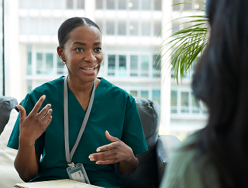 Nurse speaking with patient during appointment. Actor portrayal.