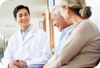 Doctor smiling with patients. Actor portrayal.