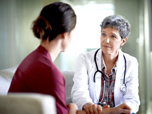 Patient speaking with Doctor. Actor portrayal.