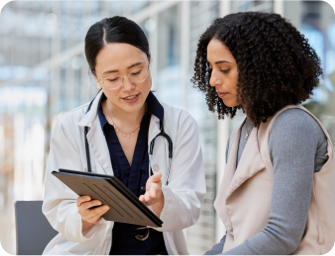 Doctor speaking with patient and reading papers. Actor portrayal.
